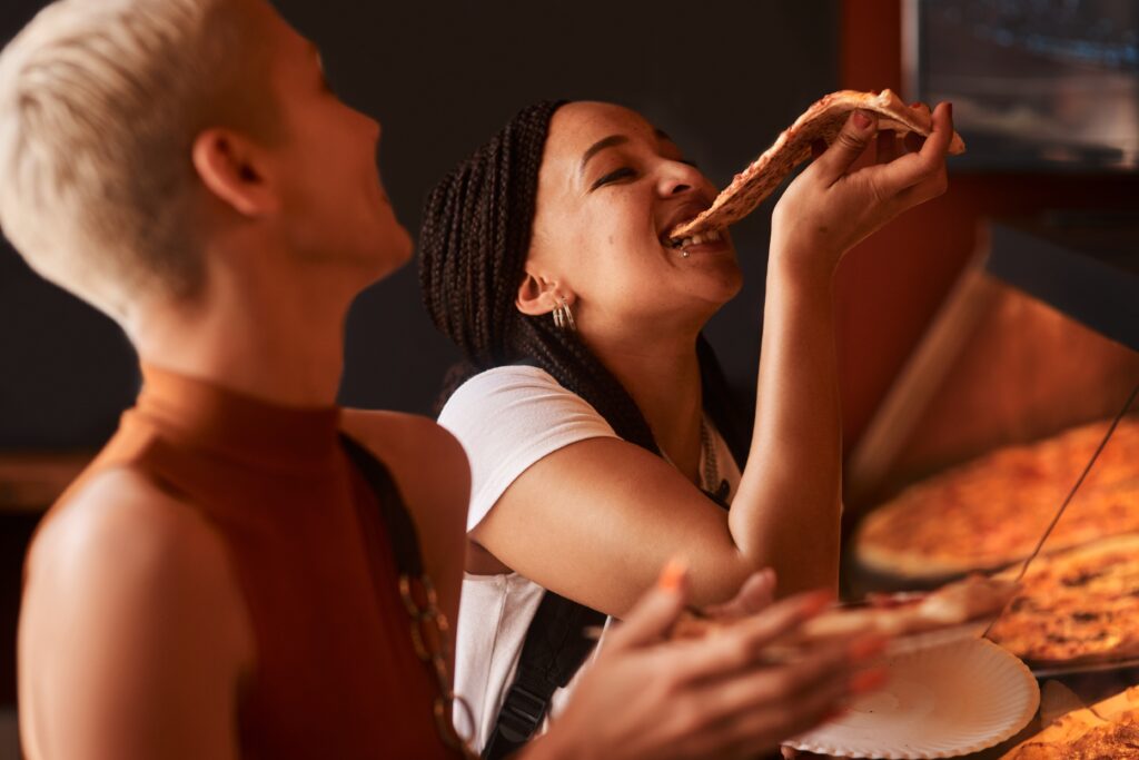 Pizza,,Friends,And,Women,Eating,Food,At,A,Restaurant,With